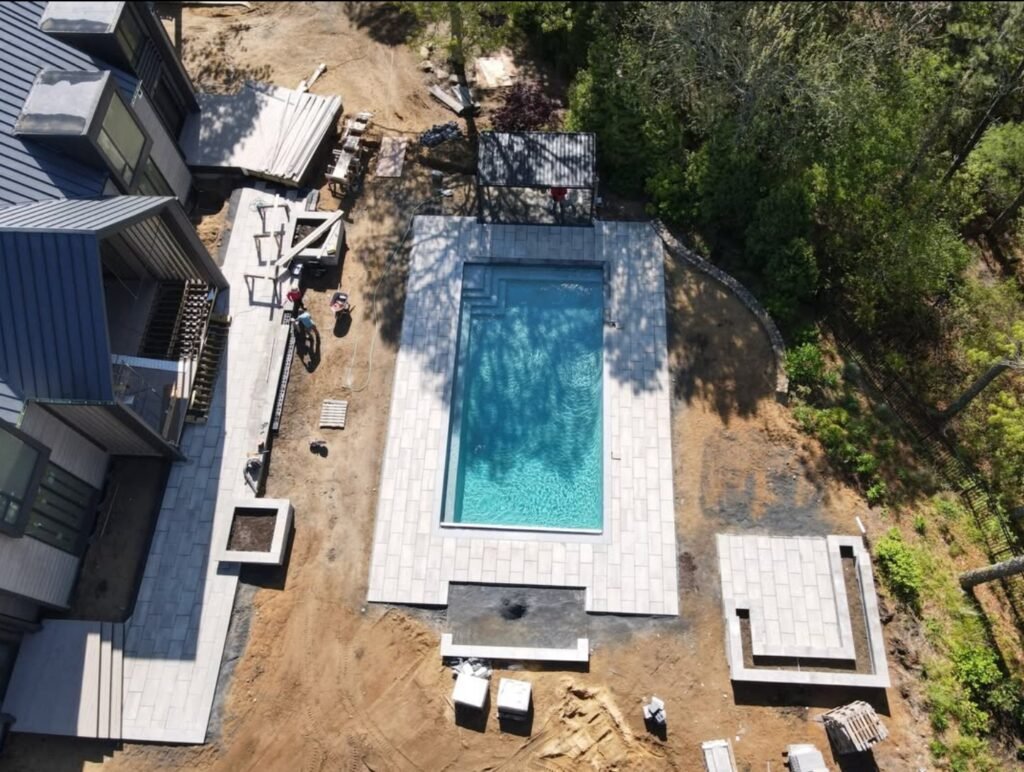Aerial view of a rectangular outdoor swimming pool under construction at a residential property on Cape Cod